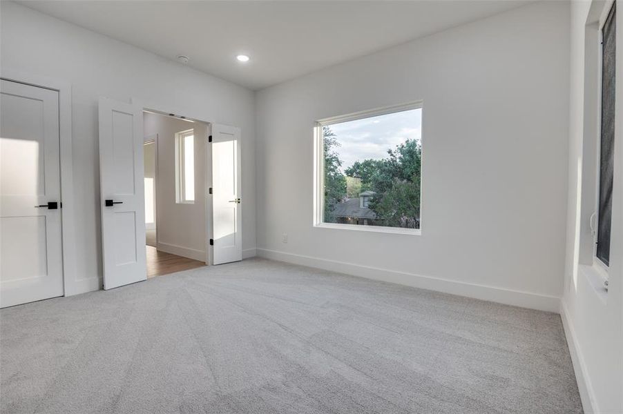 Unfurnished bedroom with carpet floors and recessed lighting Unfurnished bedroom with carpet floors and recessed lighting