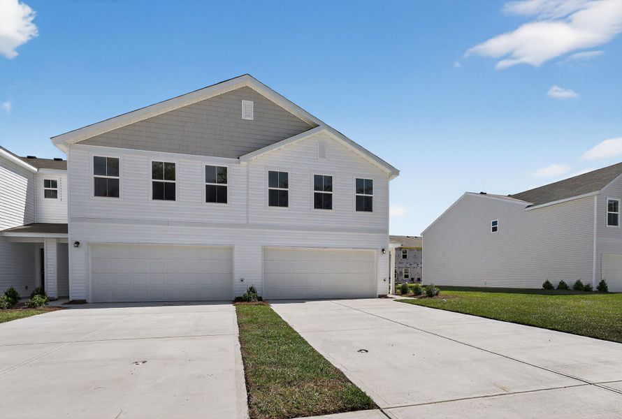 A white house with a driveway with Rockingham Meeting House in the background. A white house with a driveway with Rockingham Meeting House in the background.