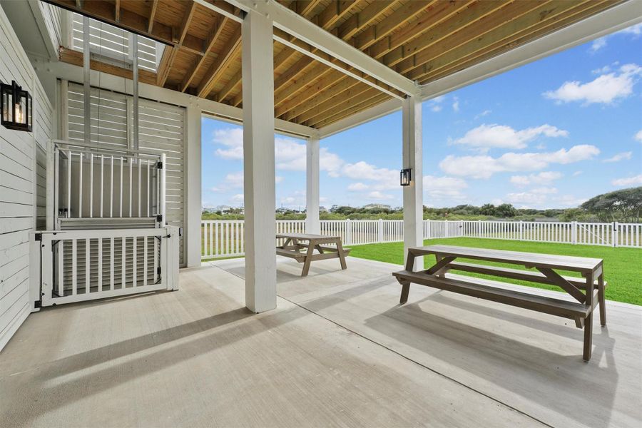 The ground level is accessible from the front garage door or from the rear staircase off of the kitchen. It showcases a spacious covered patio with two picnic tables, a gas plumbed outdoor kitchen. The home has also been upgraded with a 10K lb lift for convenience to both the first and second floors. It also has a burried Porpane Gas tank which feeds the outdoor grill and 36" gas Cafe stove in the kitchen.