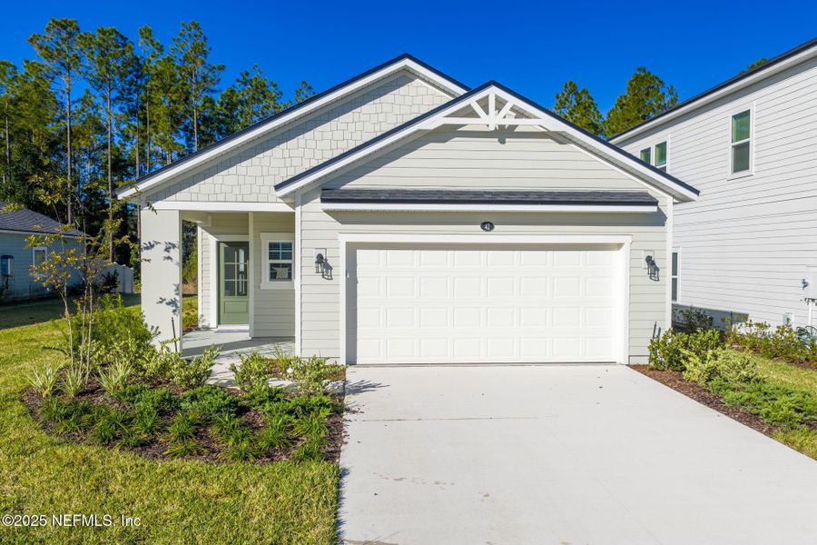 Front exterior of a new home in Beacon Lake, St. Augustine, FL, highlighting curb appeal (Image 1).