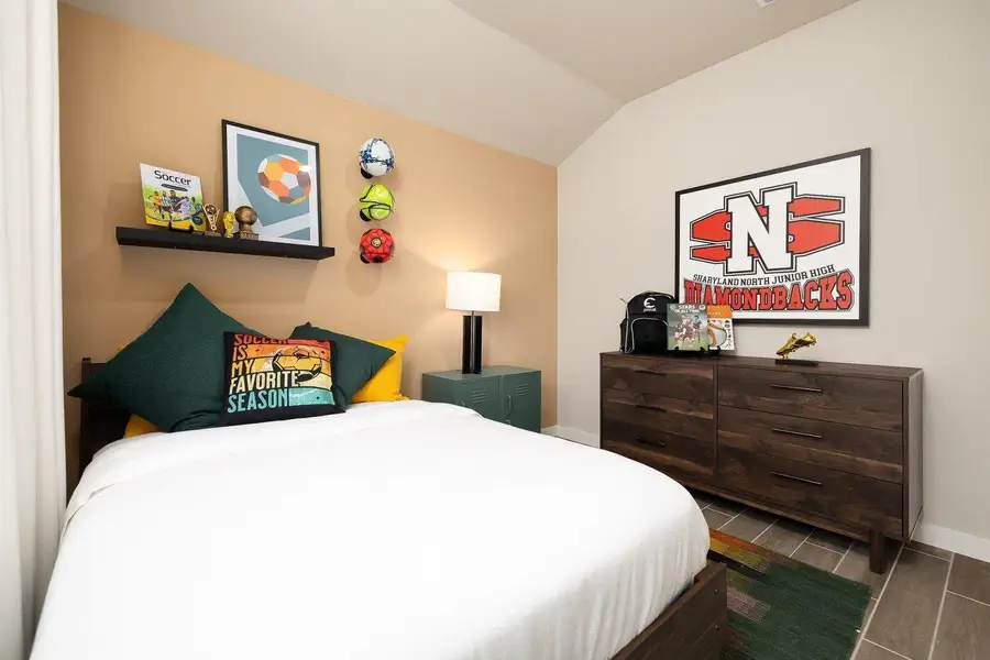 A well-lit bedroom with angled ceilings and ample space for furnishings.