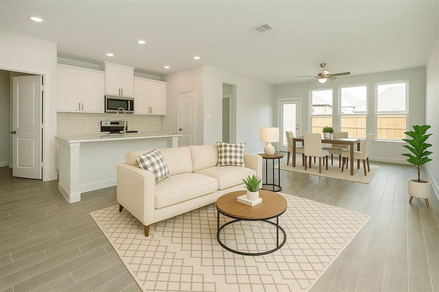 Living area with recessed lighting, wood tiled floors, and a ceiling fan Living area with recessed lighting, wood tiled floors, and a ceiling fan
