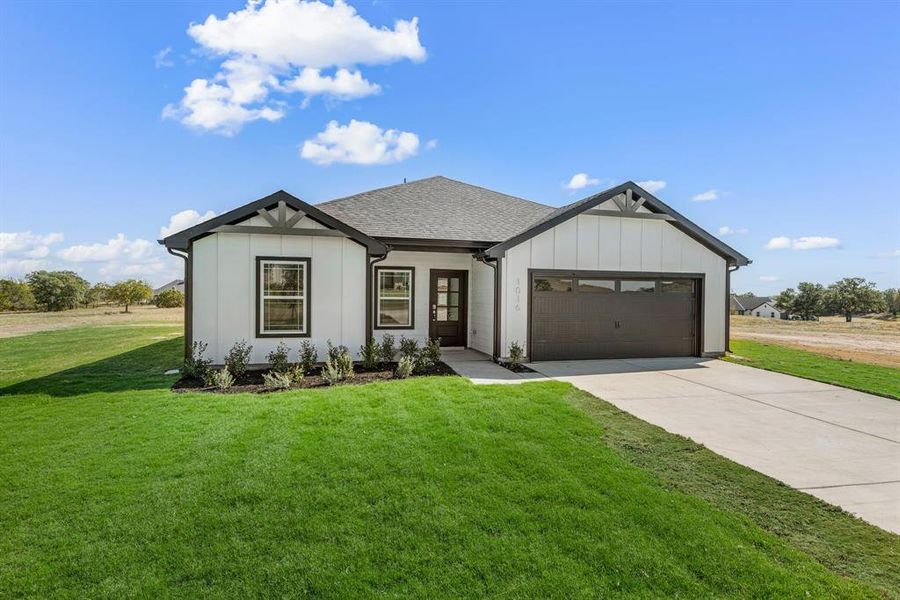 Front exterior of a new home in Gatlin Ranch, Springtown, TX, highlighting curb appeal (Image 2). Front exterior of a new home in Gatlin Ranch, Springtown, TX, highlighting curb appeal (Image 2).