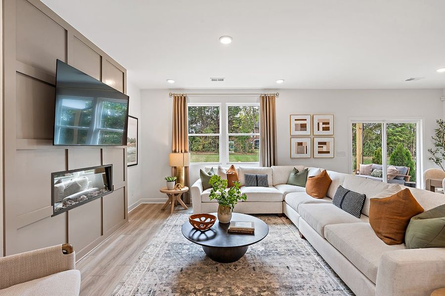 A living room with a large tv and a couch. A living room with a large tv and a couch.