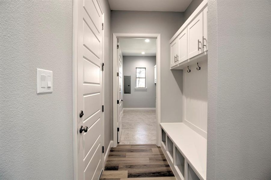 Mudroom featuring dark wood-type flooring and electric panel