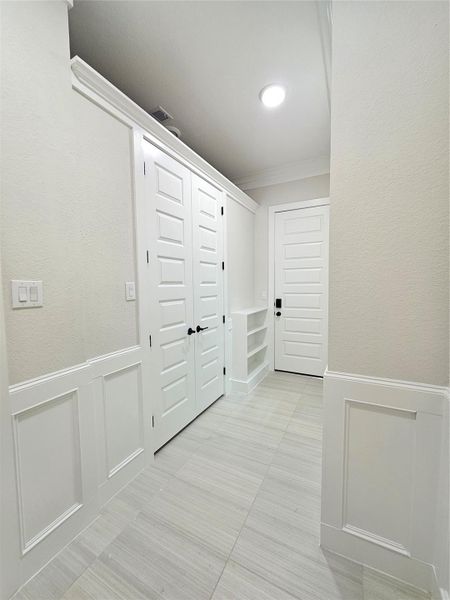 Experience convenience in this well-designed mudroom, featuring direct garage access and easy entry to the laundry area.
