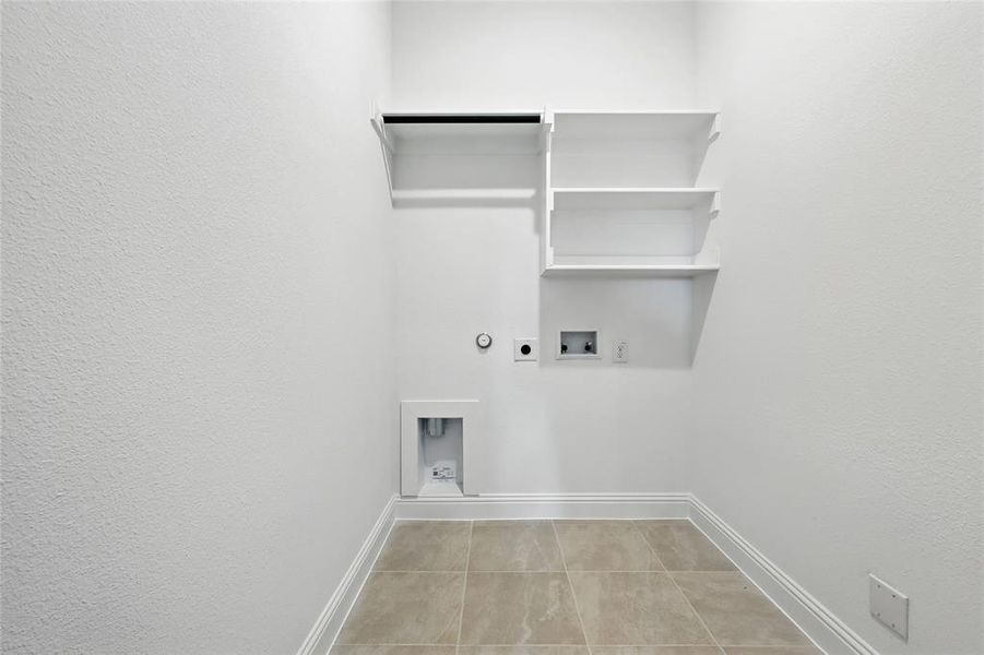 Laundry room featuring hookup for a gas dryer, hookup for an electric dryer, hookup for a washing machine, light tile patterned floors, and a textured wall