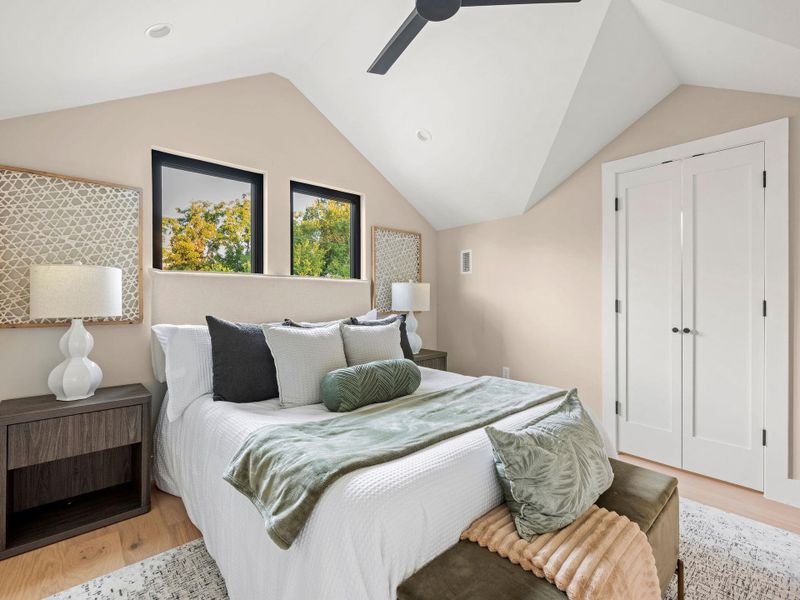 Bedroom featuring vaulted ceiling, wood finished floors, a ceiling fan, recessed lighting, and a closet Bedroom featuring vaulted ceiling, wood finished floors, a ceiling fan, recessed lighting, and a closet