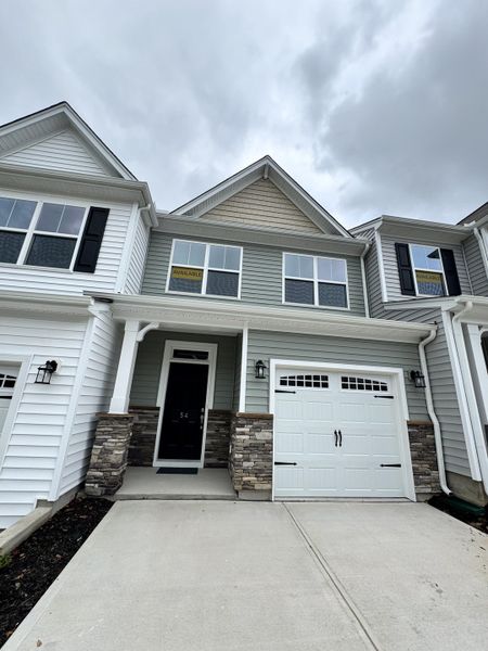 Front exterior of a new home in Fairview Village Townhomes, Simpsonville, SC, highlighting curb appeal (Image 1).