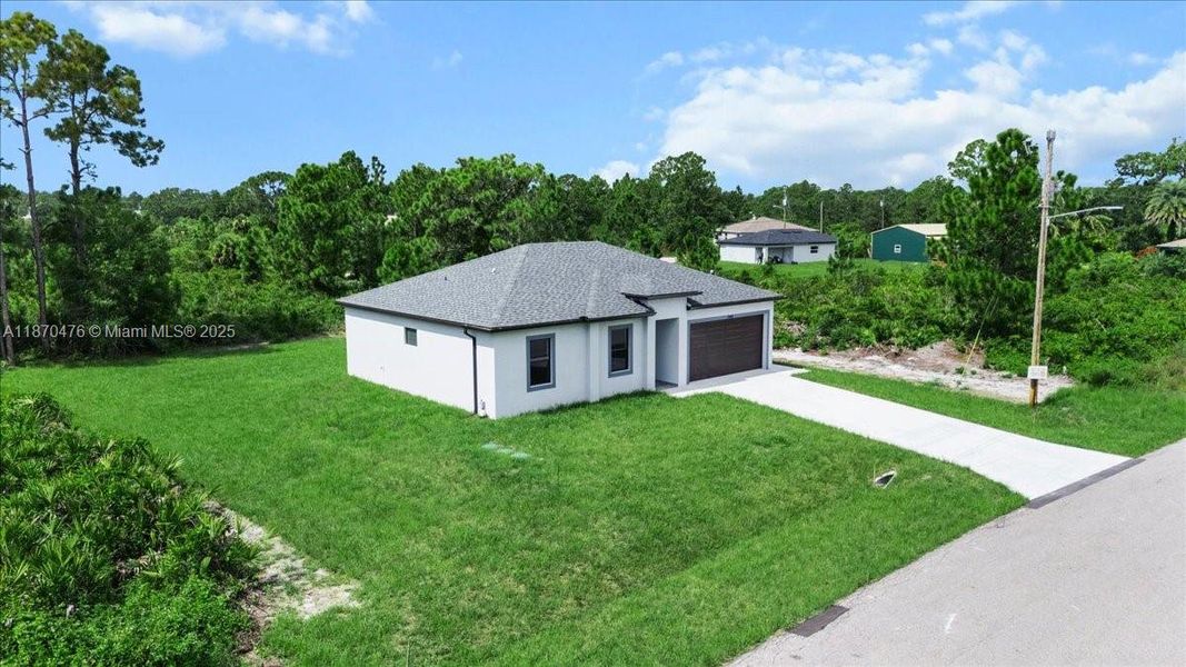 Front exterior of a new home in , Lehigh Acres, FL, highlighting curb appeal (Image 1). Front exterior of a new home in , Lehigh Acres, FL, highlighting curb appeal (Image 1).
