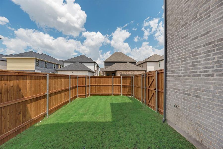 Fenced backyard featuring a residential view Fenced backyard featuring a residential view