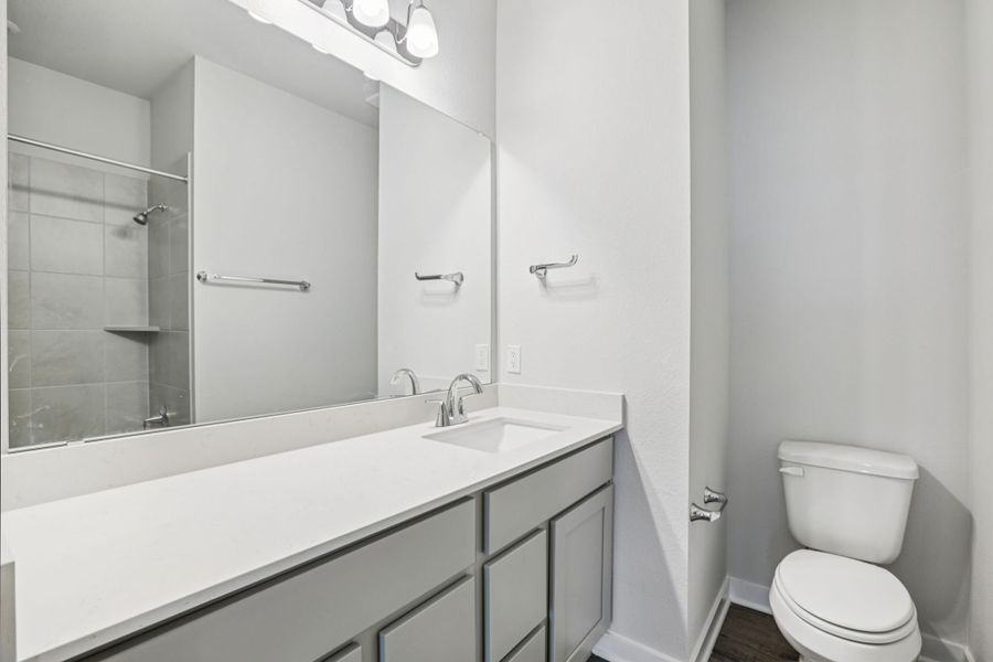 A bathroom with a tub sink and toilet. A bathroom with a tub sink and toilet.