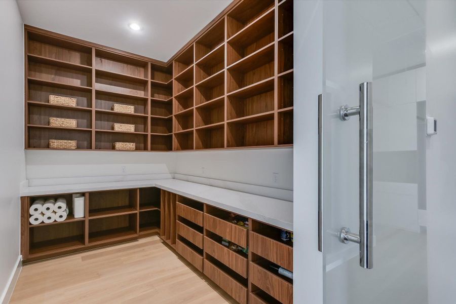 View of incredible custom pantry with lots of shelving and pull out drawers View of incredible custom pantry with lots of shelving and pull out drawers