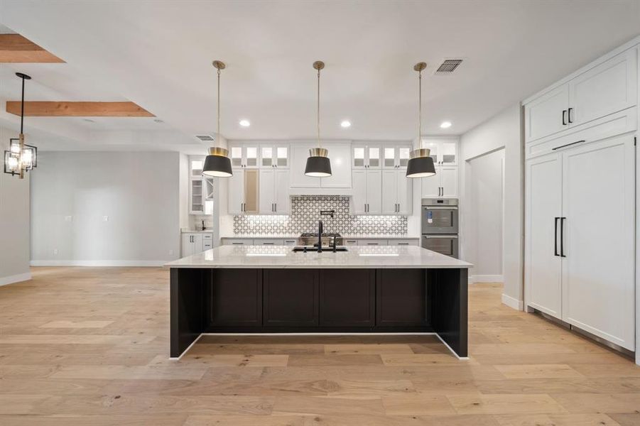 Custom designed kitchen with all the bells and whistles. Dining area and bar and wine fridge to the left.