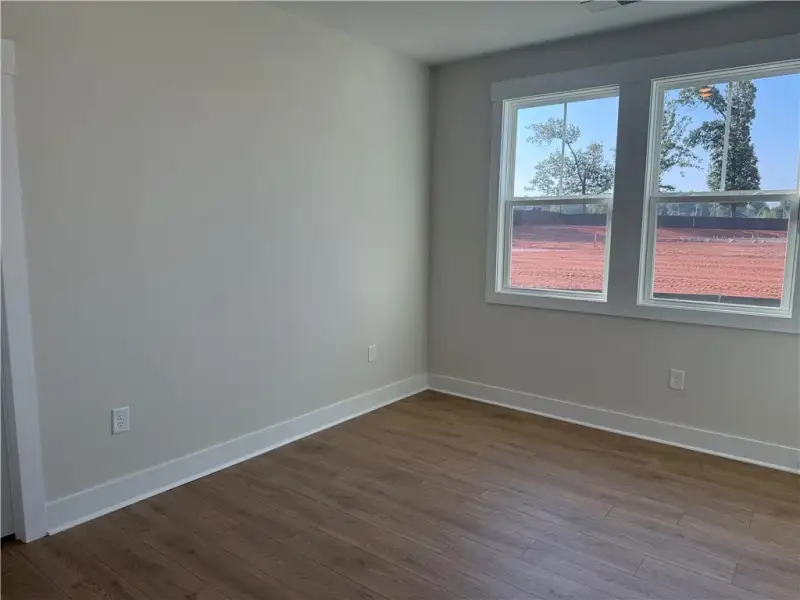 Rich wood-look flooring and crisp trim define this