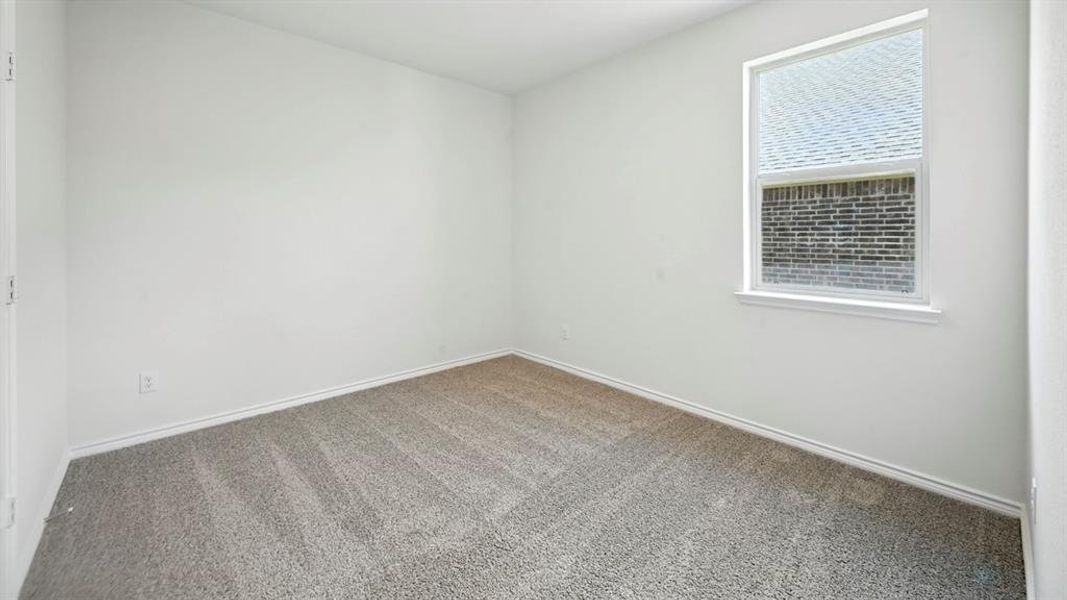 Room featuring light-colored walls, gray carpet, a single window with white trim, and white baseboards
