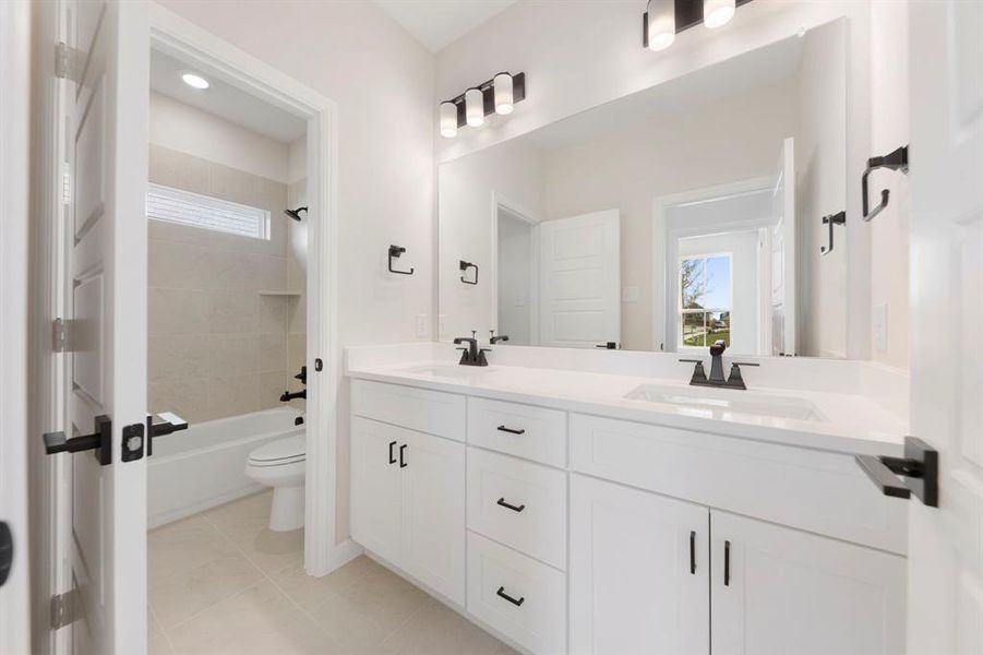 Guests will enjoy their own vanity space in this thoughtfully designed guest bath.