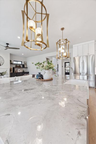 Stunning super white quartzite and designer pendant lights.