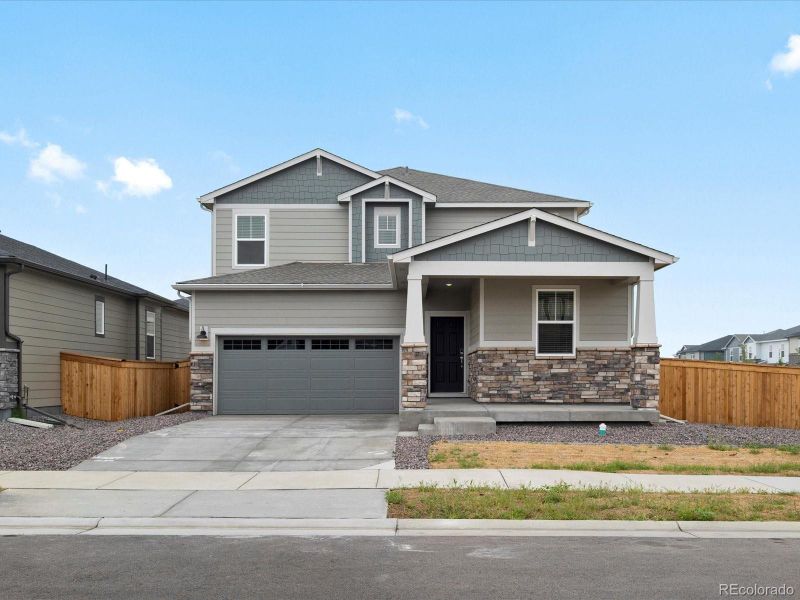 Front exterior of a new home in Ridgeline Vista: The Flora Collection, Brighton, CO, highlighting curb appeal (Image 2). Front exterior of a new home in Ridgeline Vista: The Flora Collection, Brighton, CO, highlighting curb appeal (Image 2).