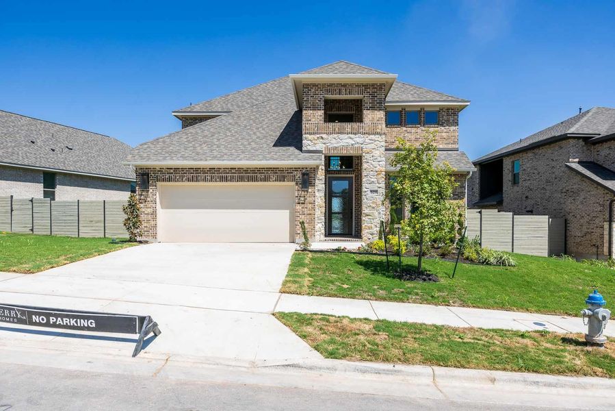 Front exterior of a new home in Wolf Ranch, Georgetown, TX, highlighting curb appeal (Image 2).