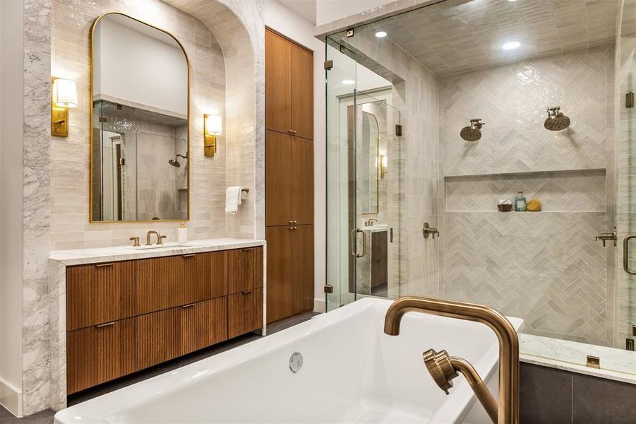A soaking tub and a walk in shower with dual shower heads create a bathroom designed for both relaxation and everyday use