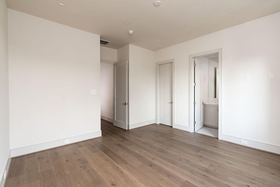 The second-floor secondary bedroom, like all the secondary bedrooms, features a large walk in closet as well as the en-suite bathroom. The second-floor secondary bedroom, like all the secondary bedrooms, features a large walk in closet as well as the en-suite bathroom.