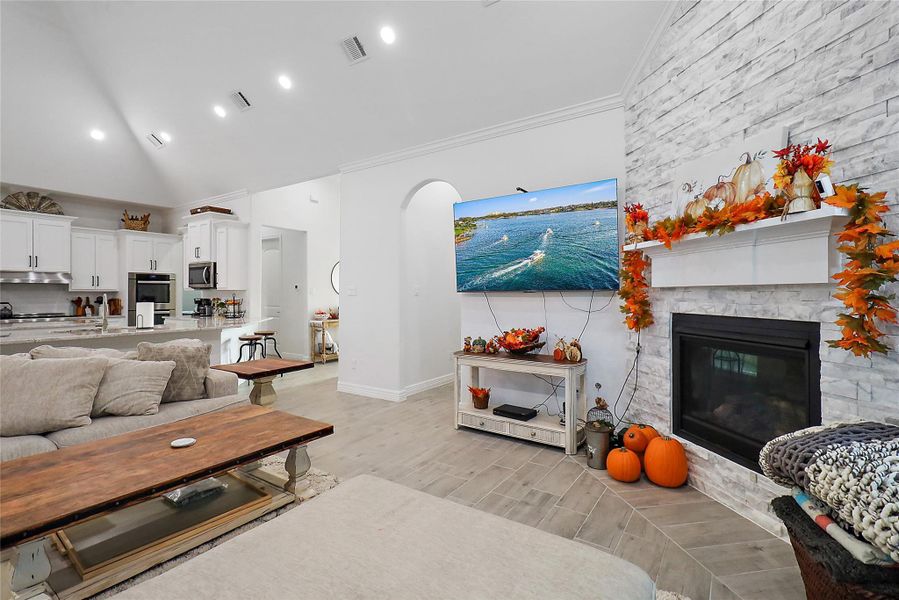 Gas fireplace with stone facade to ceiling.