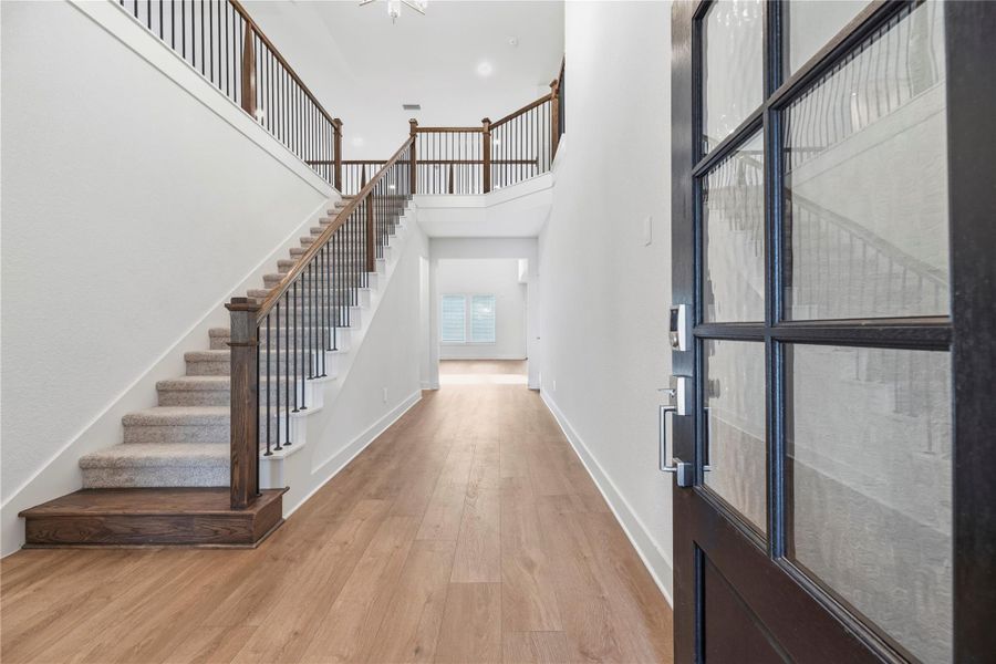 Inviting front entry offers stunning LVP flooring, neutral paint and high ceilings.