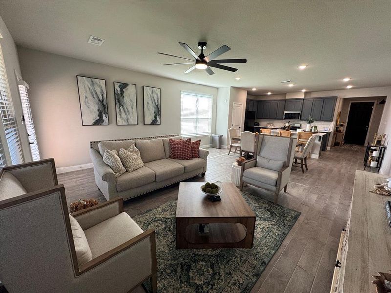 Living room with dark wood finished floors, recessed lighting, and ceiling fan Living room with dark wood finished floors, recessed lighting, and ceiling fan