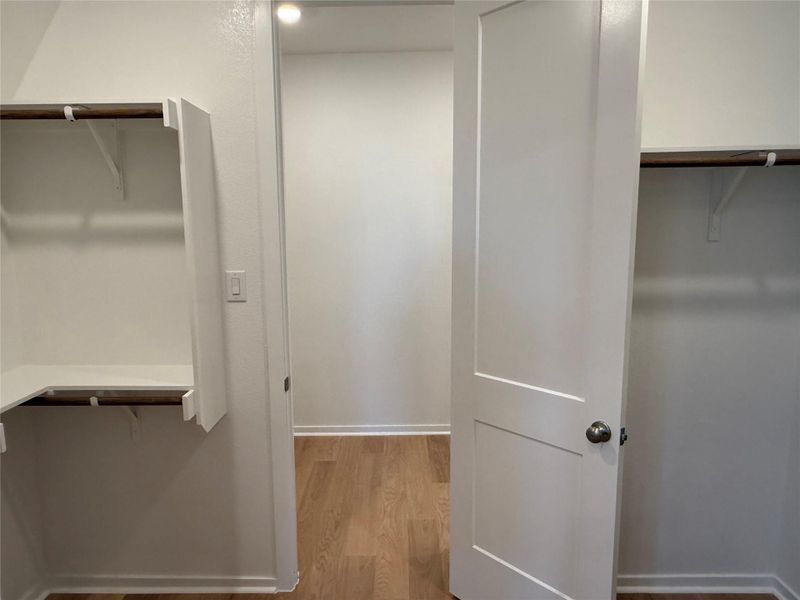 Spacious closet featuring light wood-style floors Spacious closet featuring light wood-style floors