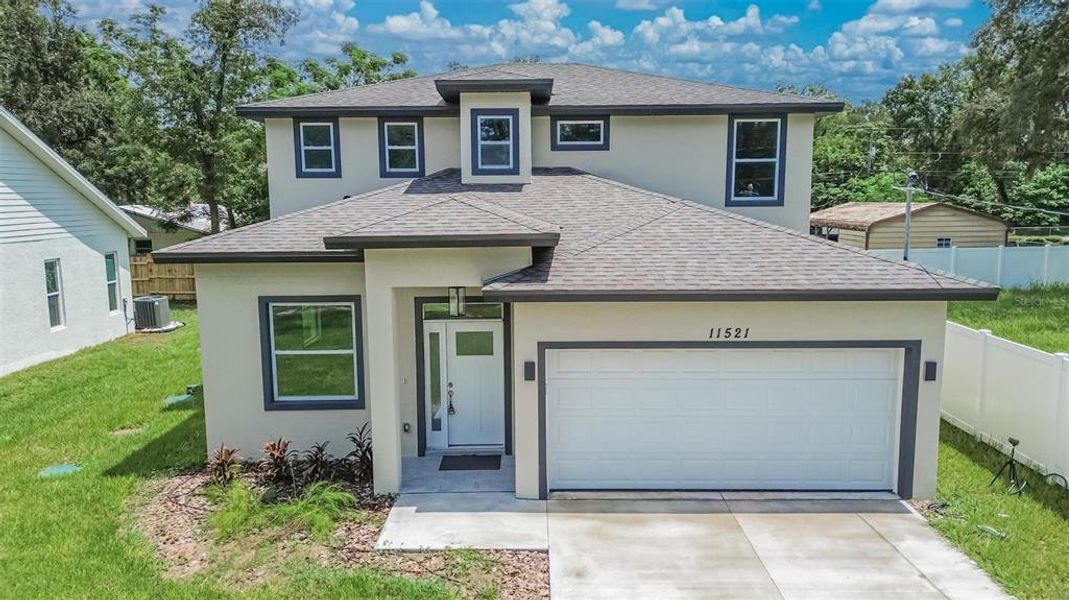 Front exterior of a new home in , Thonotosassa, FL, highlighting curb appeal (Image 20). Front exterior of a new home in , Thonotosassa, FL, highlighting curb appeal (Image 20).