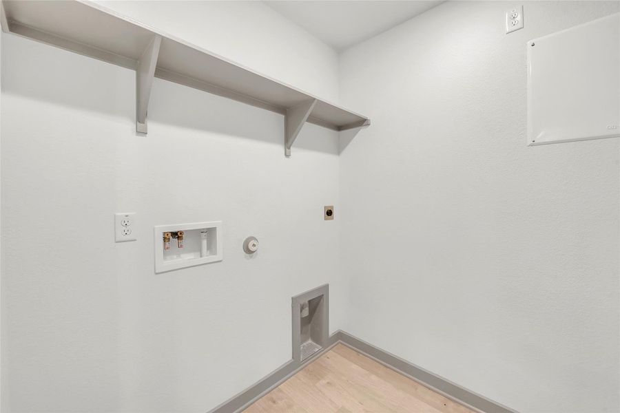 Laundry area featuring gas dryer hookup, light wood-style floors, hookup for a washing machine, and hookup for an electric dryer