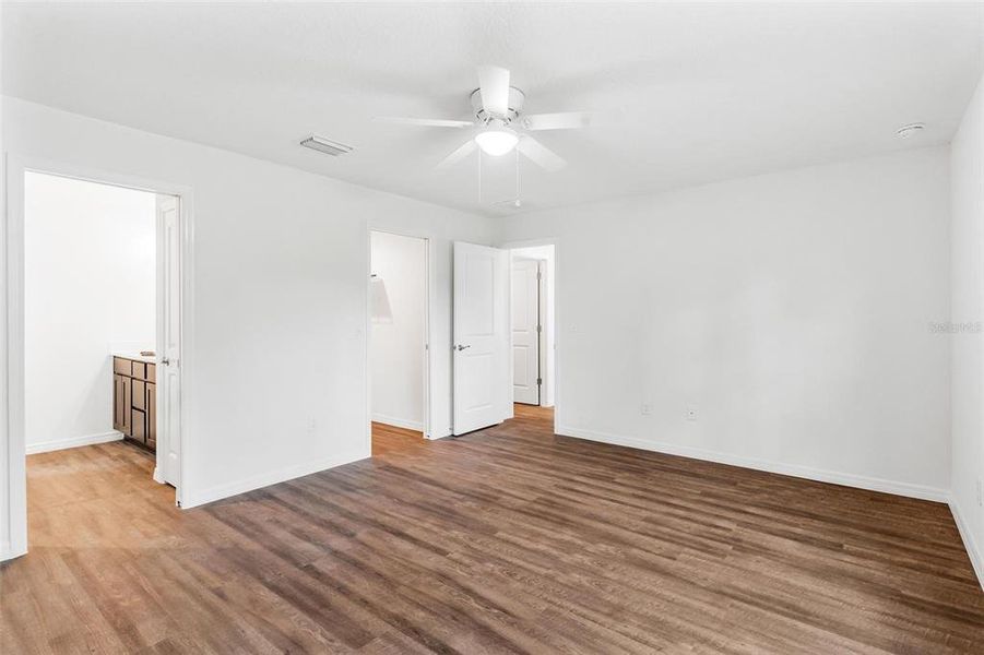 Primary Bedroom with Luxury Vinyl Plank Flooring