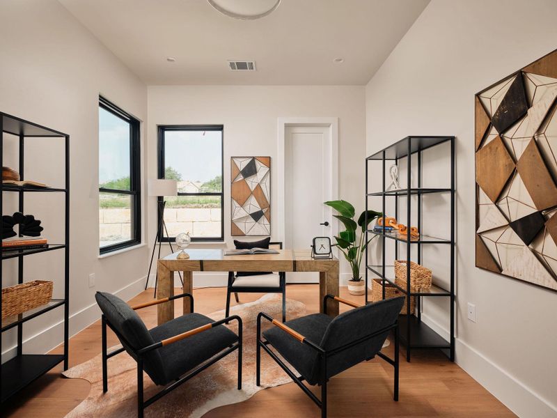 A refined home office space with rich wood flooring and a tranquil ambiance. A refined home office space with rich wood flooring and a tranquil ambiance.