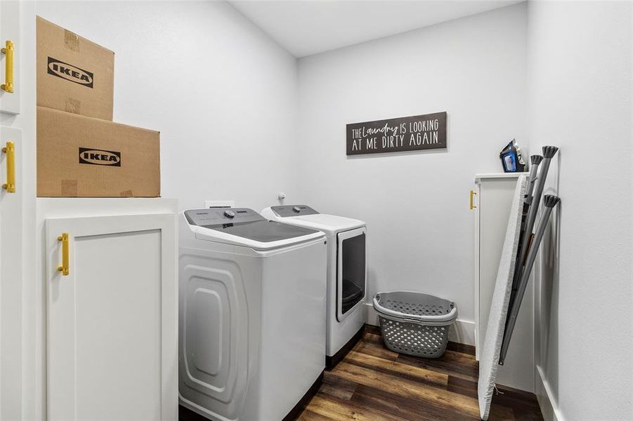 Laundry room with built in cabinets and plenty of space to move around