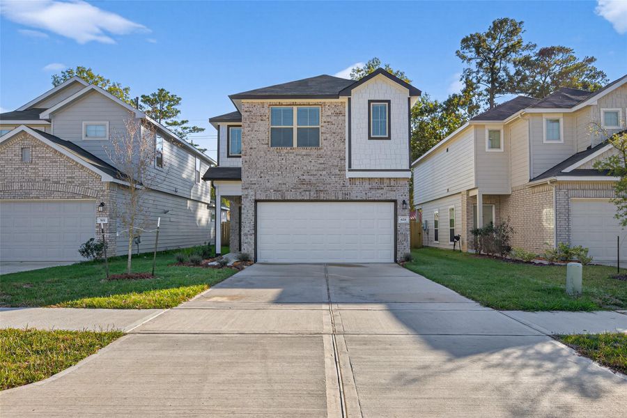 Front exterior of a new home in Woodland Lakes, Huffman, TX, highlighting curb appeal (Image 28). Front exterior of a new home in Woodland Lakes, Huffman, TX, highlighting curb appeal (Image 28).