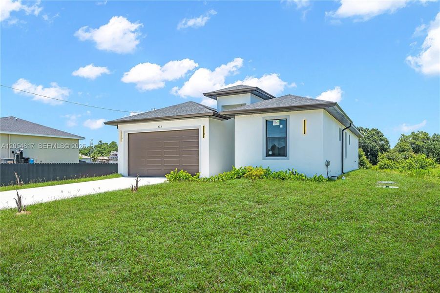 Front exterior of a new home in , Lehigh Acres, FL, highlighting curb appeal (Image 2). Front exterior of a new home in , Lehigh Acres, FL, highlighting curb appeal (Image 2).