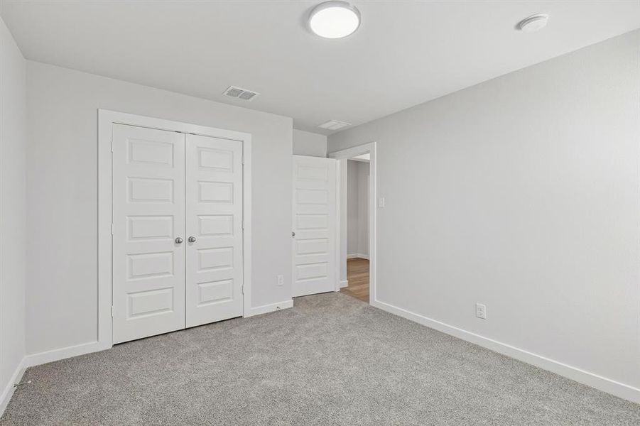 Bedroom in the Harrison home plan by Trophy Signature Homes – REPRESENTATIVE PHOTO