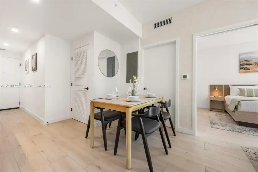 Wood-finish flooring, recessed lighting, and louvered-style closet doors Wood-finish flooring, recessed lighting, and louvered-style closet doors
