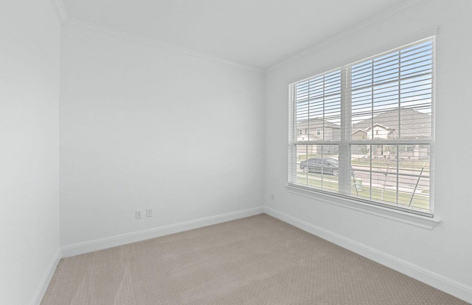 Spare room featuring ornamental molding and light colored carpet Spare room featuring ornamental molding and light colored carpet