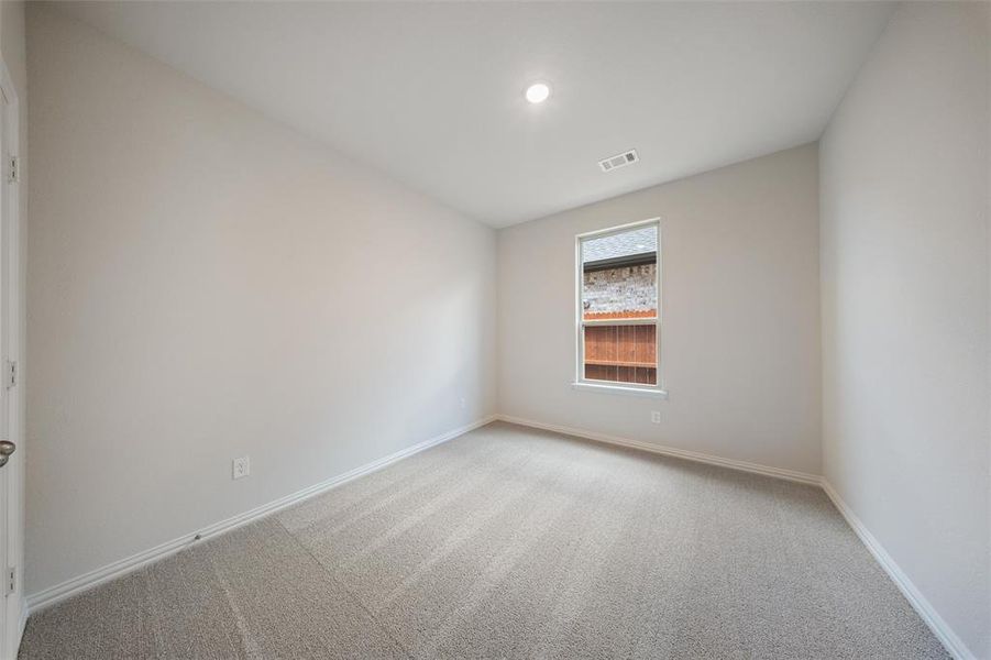 Carpeted spare room with baseboards