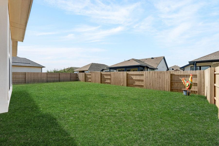 View of the large backyard. Plenty of room for entertaining, the kids, or the pets.