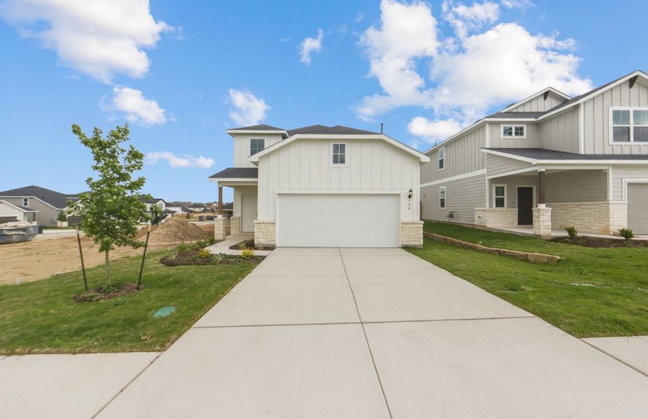 Front exterior of a new home in Sunfield, Buda, TX, highlighting curb appeal (Image 19). Front exterior of a new home in Sunfield, Buda, TX, highlighting curb appeal (Image 19).