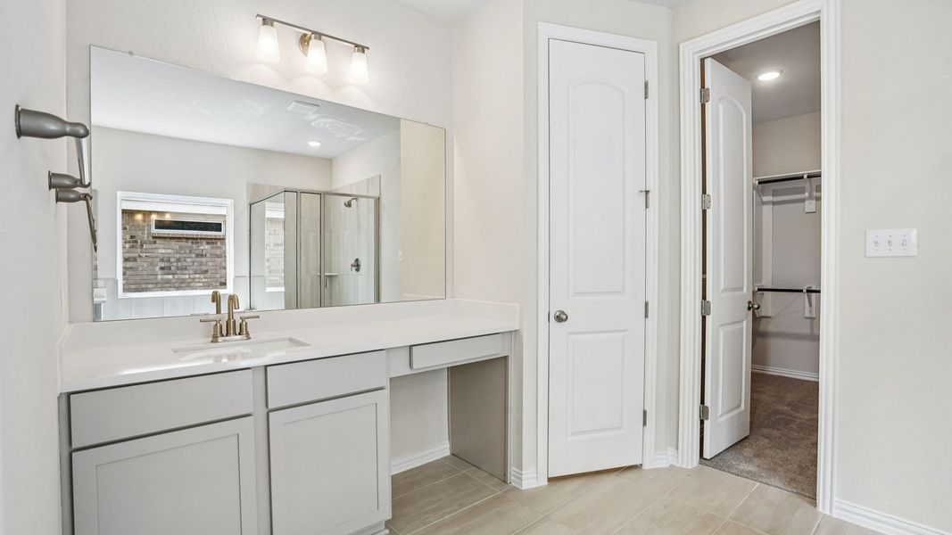 Luxurious Owner's Bath with Garden Tub, Glass Enclosed Shower, and Separate Vanities