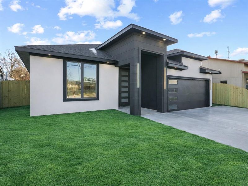View of front of home featuring driveway, stucco siding, a garage, and roof with shingles View of front of home featuring driveway, stucco siding, a garage, and roof with shingles