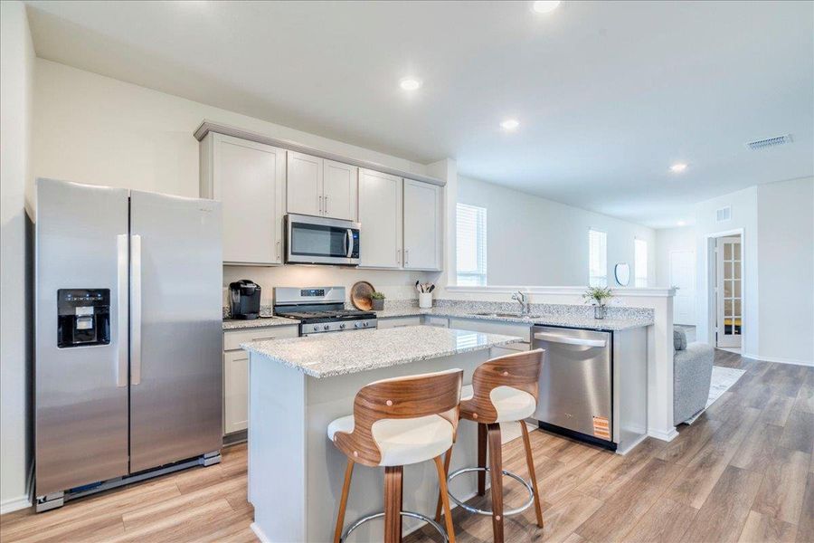 Kitchen features stainless appliances, center island, granite counters, LVP and recessed lighting Kitchen features stainless appliances, center island, granite counters, LVP and recessed lighting