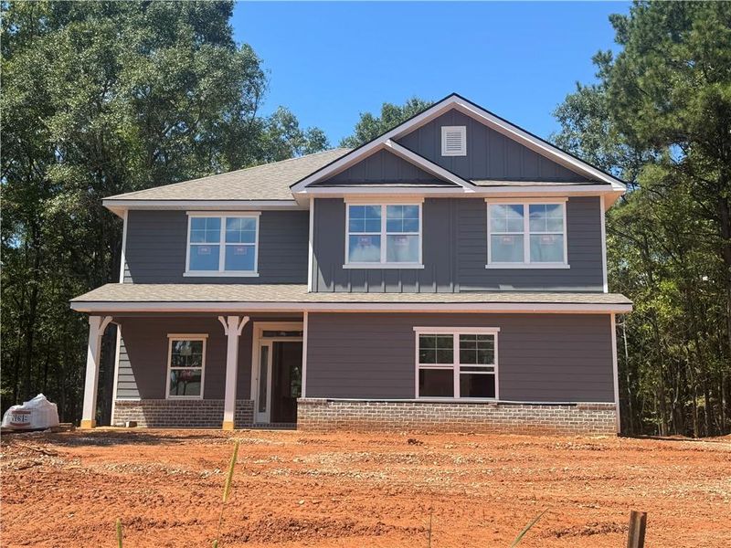 Front exterior of a new home in The Fields of Walnut Creek, Pendergrass, GA, highlighting curb appeal (Image 17). Front exterior of a new home in The Fields of Walnut Creek, Pendergrass, GA, highlighting curb appeal (Image 17).