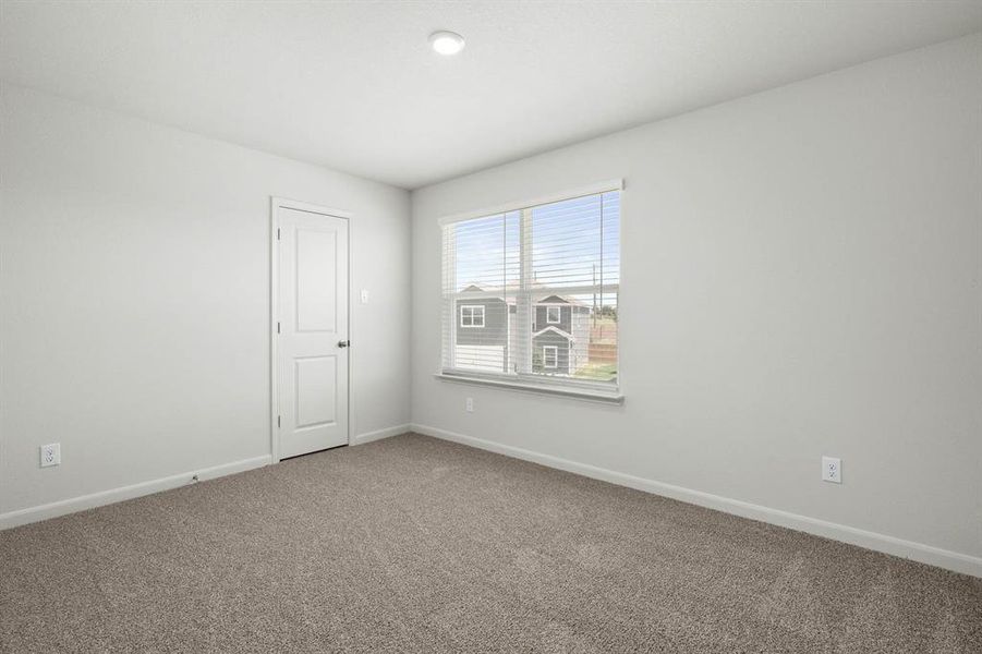 Unfurnished room with baseboards and carpet flooring
