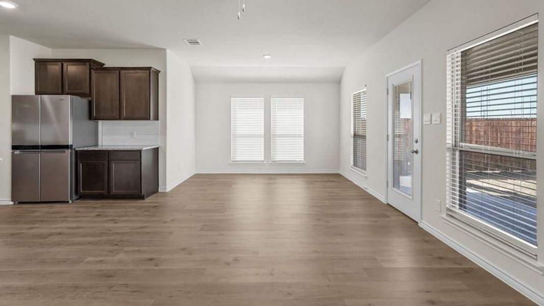 Open concept living area featuring wood-look flooring and white walls
