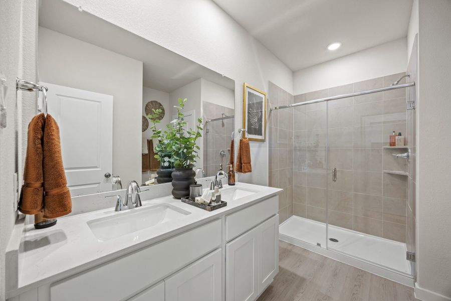 A bathroom with a glass shower. A bathroom with a glass shower.